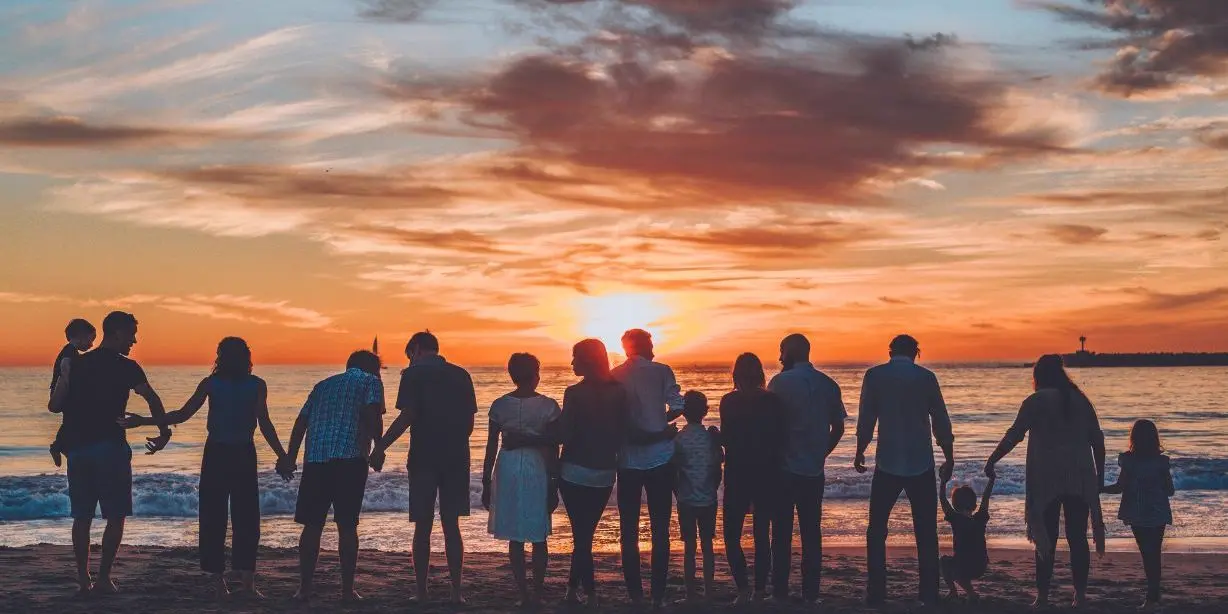 Family on the beach at sunset